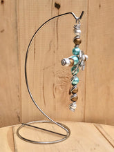 Load image into Gallery viewer, Teal and Gold Beaded Display Cross with Swirled Center and Silver Stand