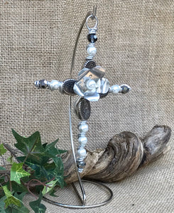 Decorative Silver Beaded Cross with White Pearlized and Silver Beads. Centered is a Silver Flower with a Pearl Bead Center. Silver Stand is Included.